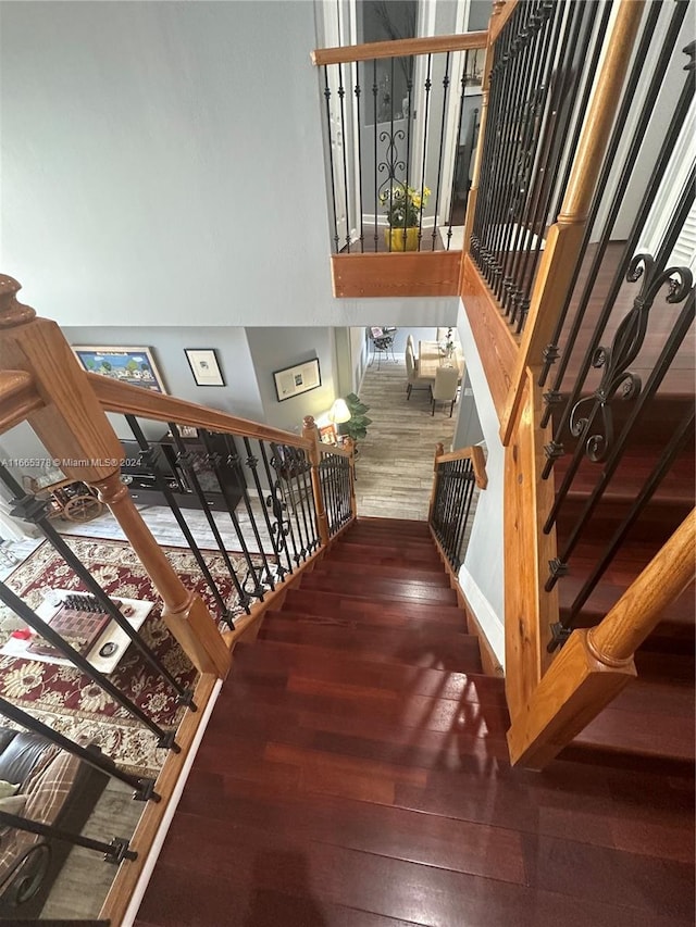 staircase with hardwood / wood-style floors