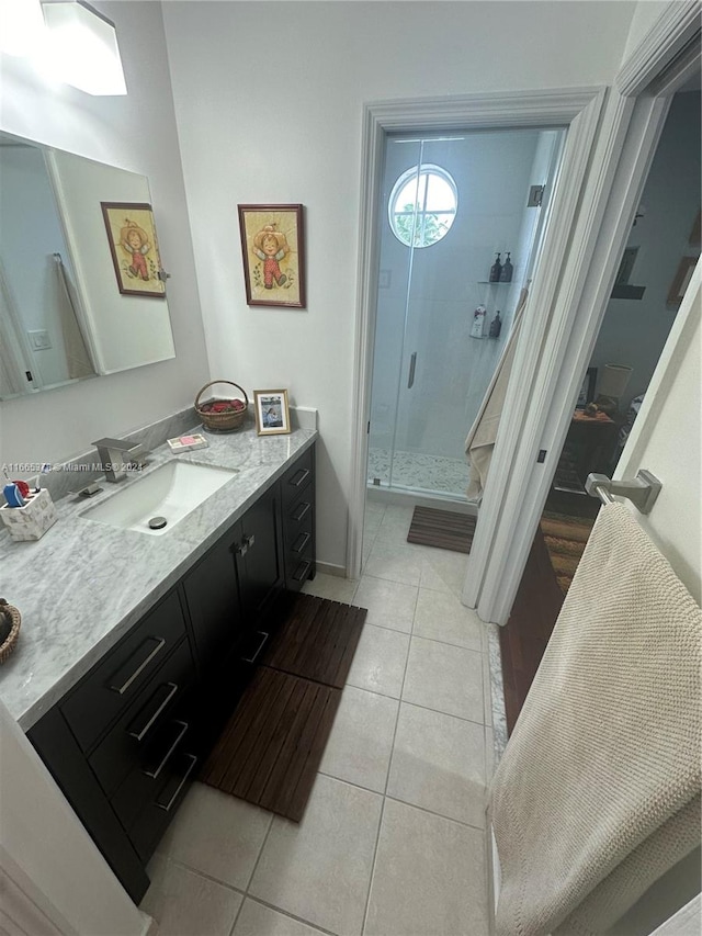 bathroom featuring tile patterned flooring, vanity, and an enclosed shower