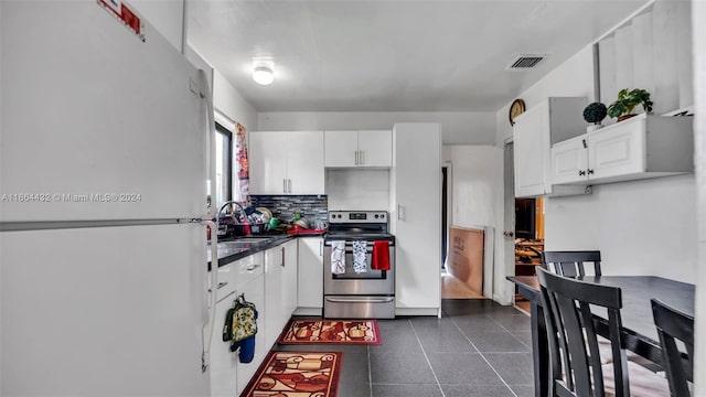 kitchen featuring sink, tasteful backsplash, stainless steel electric range, white cabinetry, and white fridge