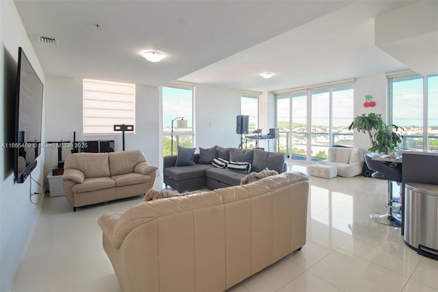 tiled living room featuring expansive windows