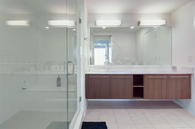 bathroom featuring walk in shower, vanity, and tile patterned flooring