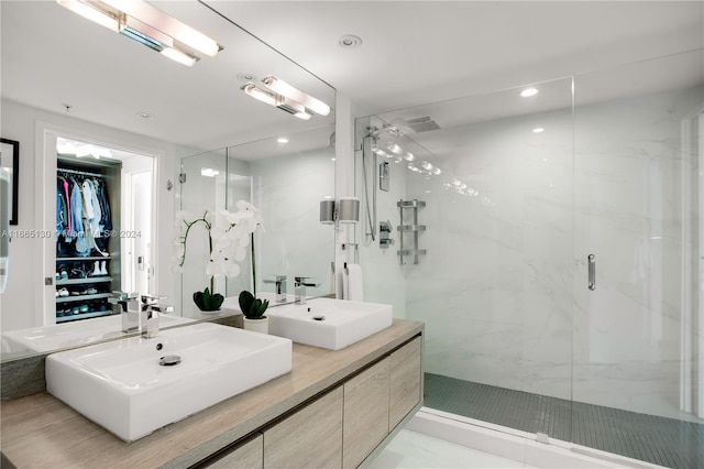 bathroom with vanity and a shower with door