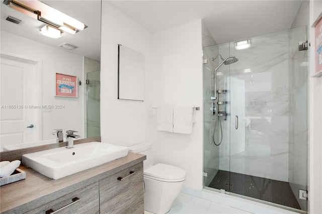 bathroom with vanity, toilet, and an enclosed shower