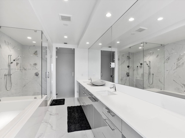 bathroom with vanity and shower with separate bathtub