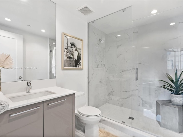 bathroom with vanity, toilet, and an enclosed shower