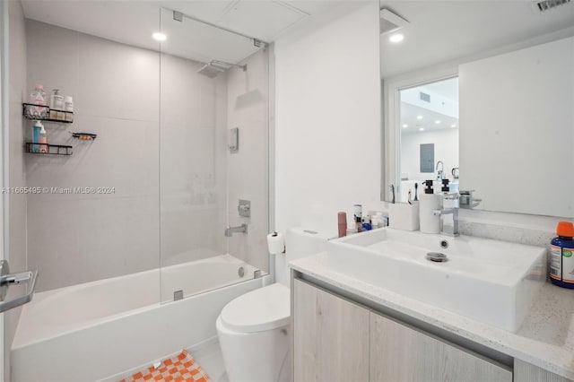 full bathroom featuring vanity, toilet, and tiled shower / bath