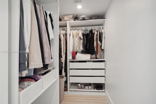 spacious closet with light hardwood / wood-style flooring