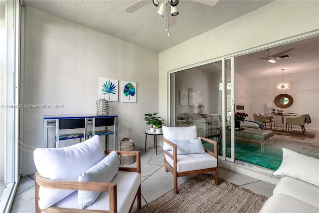 interior space featuring ceiling fan and a textured ceiling