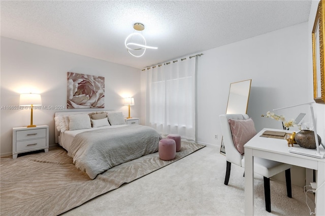 carpeted bedroom featuring a textured ceiling