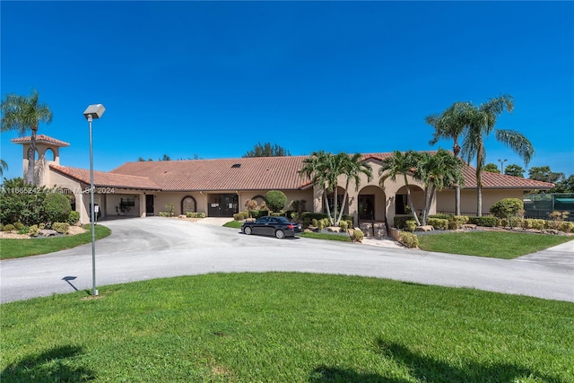 mediterranean / spanish-style home featuring a front yard