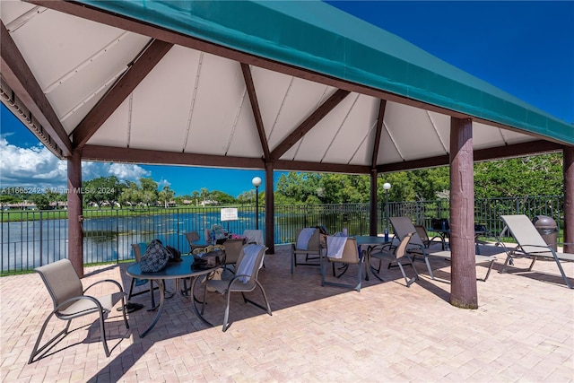 view of patio with a gazebo and a water view