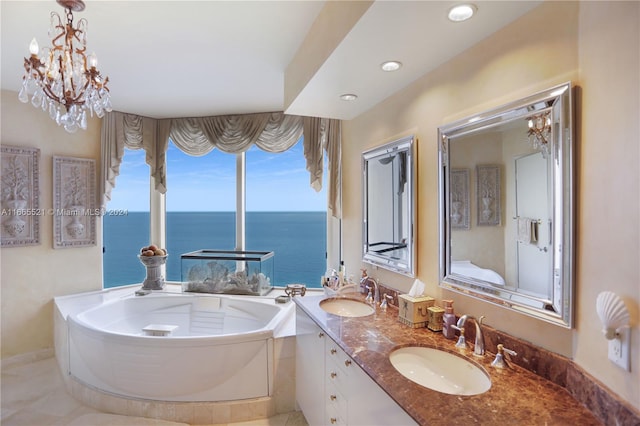 bathroom with a tub to relax in, a water view, vanity, and an inviting chandelier