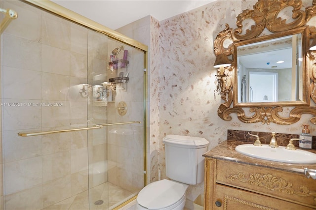 bathroom featuring walk in shower, vanity, and toilet