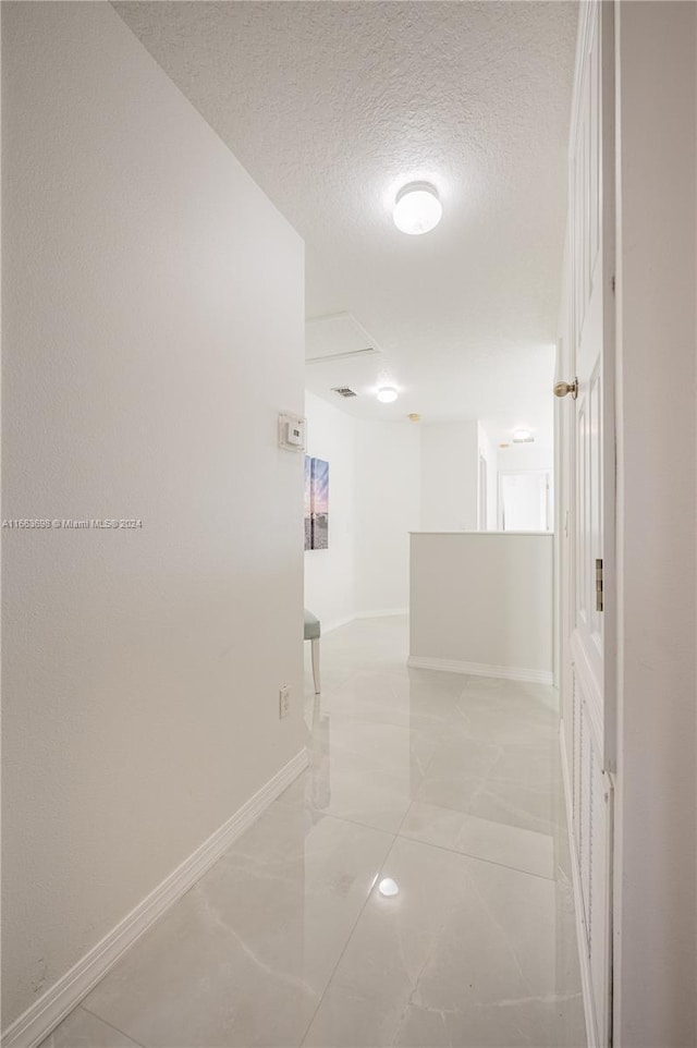 corridor with a textured ceiling