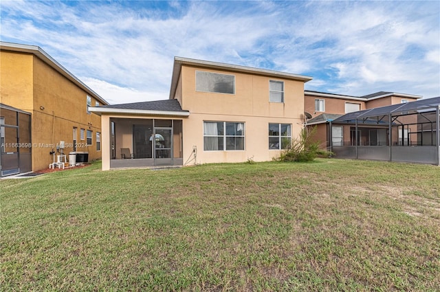 back of property featuring central AC unit, a sunroom, and a yard