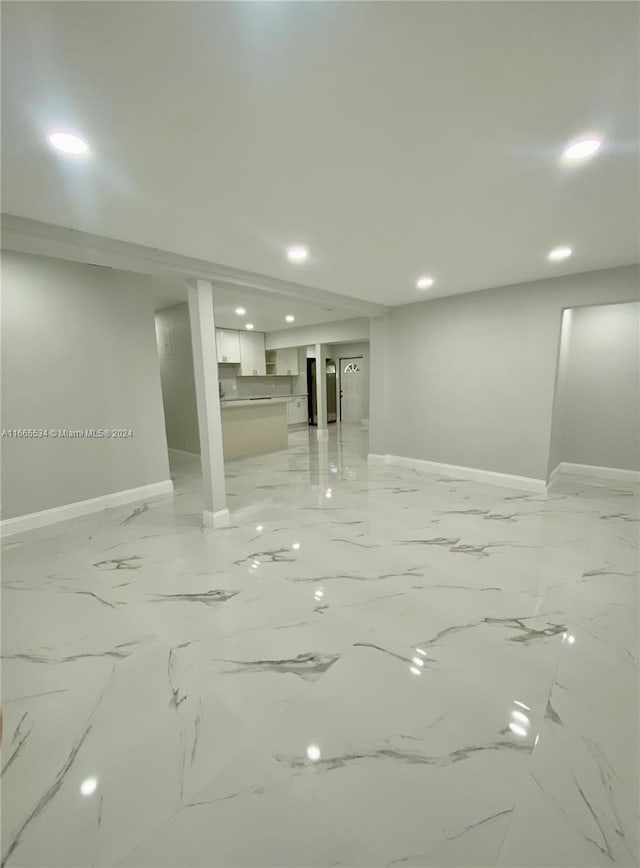 below grade area with baseboards and recessed lighting