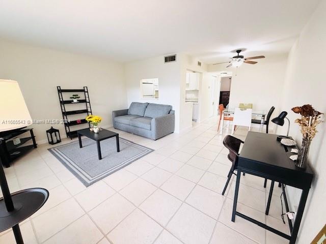 living room featuring ceiling fan and light tile patterned floors