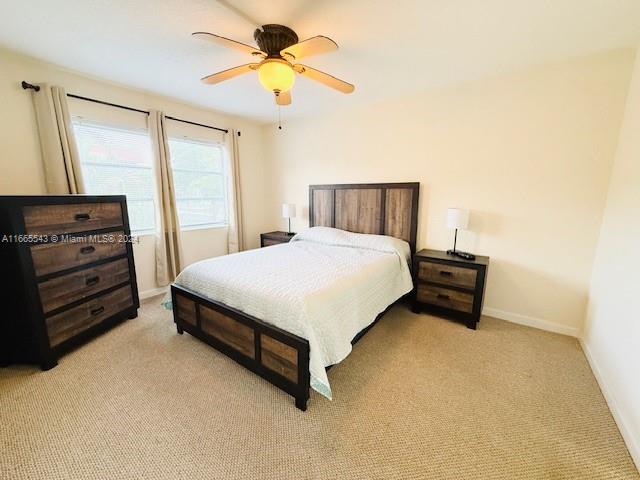 carpeted bedroom with ceiling fan