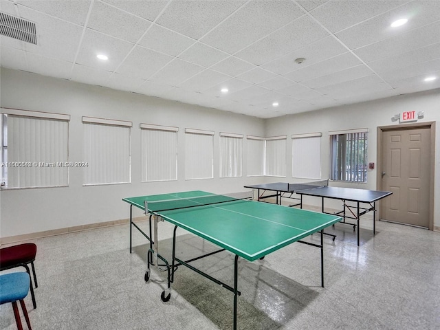 game room with a paneled ceiling