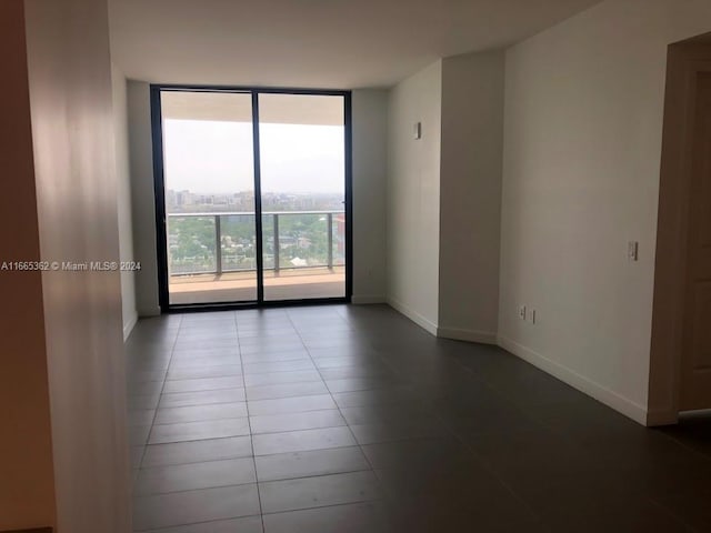 tiled spare room with expansive windows