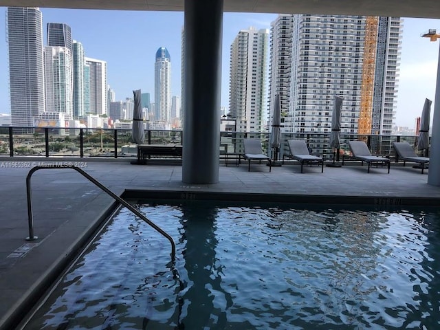 view of pool with a water view