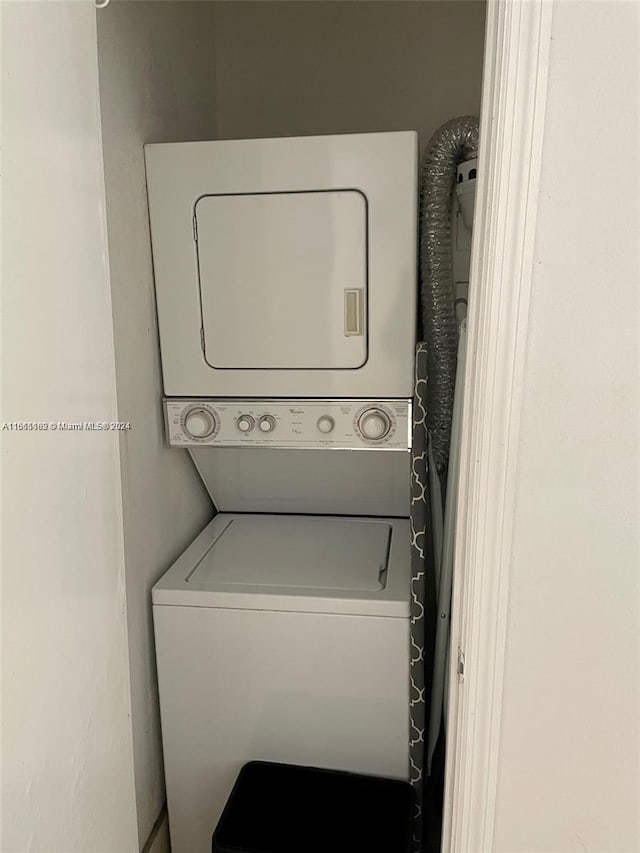 laundry room with stacked washer / drying machine