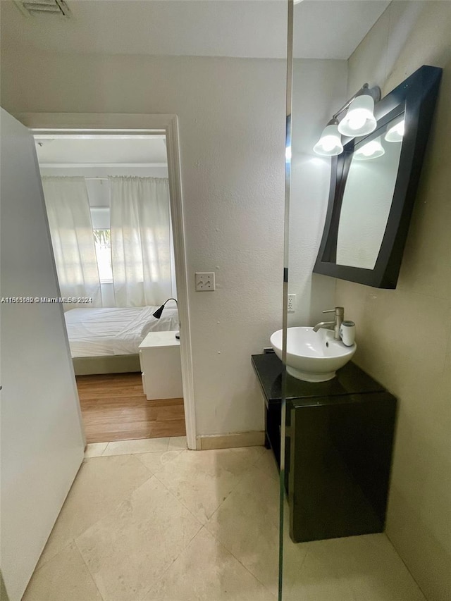 bathroom with wood-type flooring and vanity