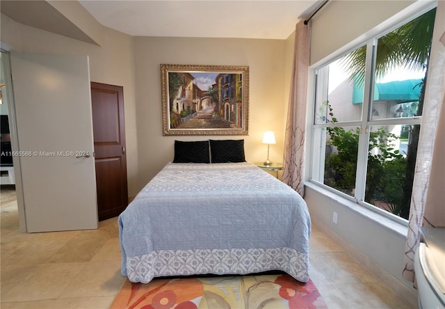 bedroom featuring light tile patterned floors