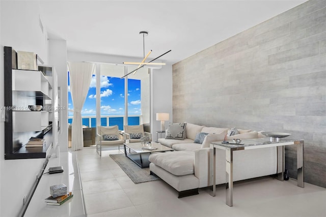 living room featuring an inviting chandelier and a water view