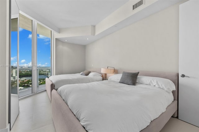 bedroom featuring floor to ceiling windows, access to exterior, and multiple windows