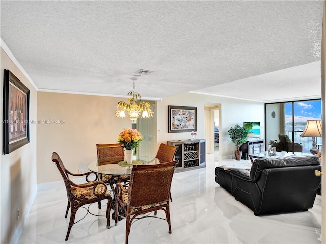 dining room featuring a textured ceiling, ornamental molding, and an inviting chandelier