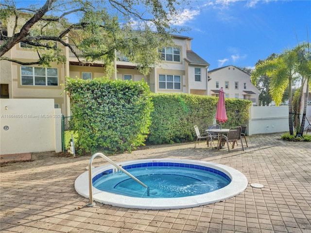 view of swimming pool with an in ground hot tub and a patio area