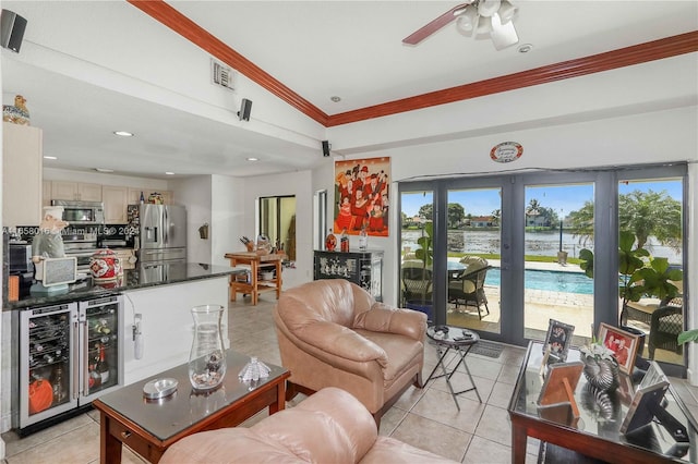 living room with beverage cooler, vaulted ceiling, light tile patterned floors, ornamental molding, and ceiling fan