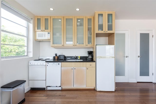 kitchen featuring light brown cabinetry, white appliances, dark hardwood / wood-style floors, and sink