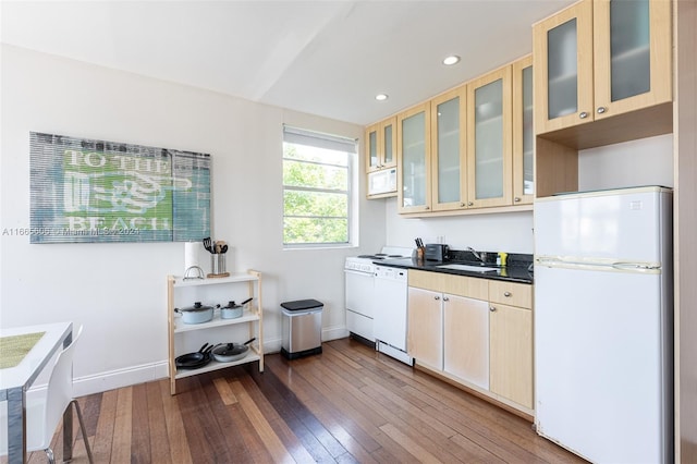 420 15th St Unit 307, Miami Beach, FL 33139 - kitchen featuring white appliances, dark wood finished floors, baseboards, a sink, and dark countertops