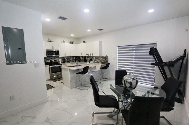 dining area featuring electric panel and sink