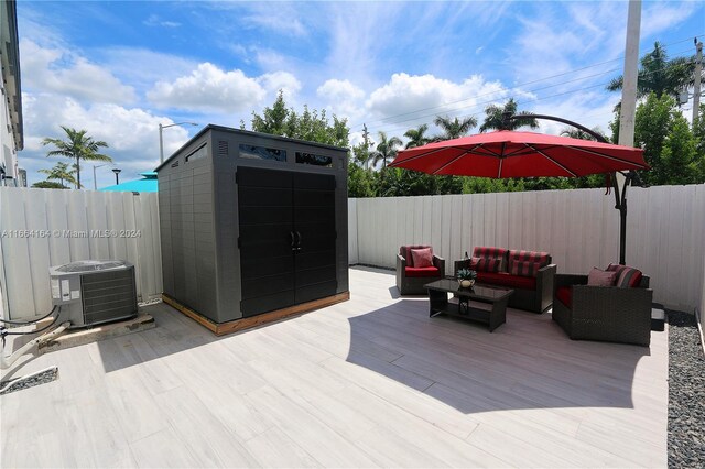 wooden terrace featuring a shed and central air condition unit