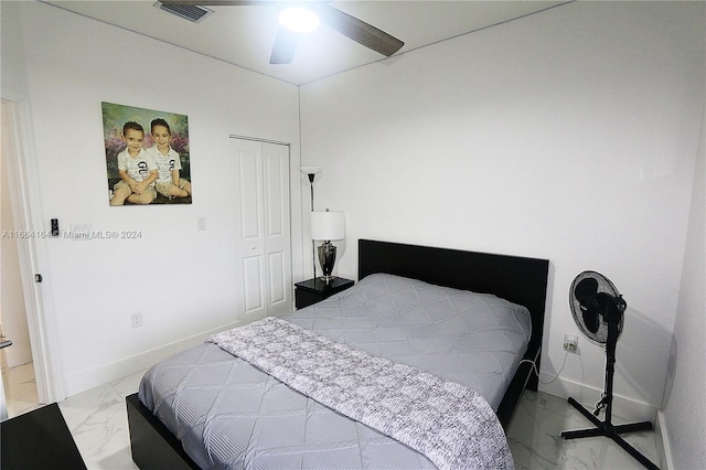 bedroom featuring ceiling fan and a closet