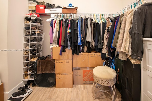 walk in closet with wood-type flooring