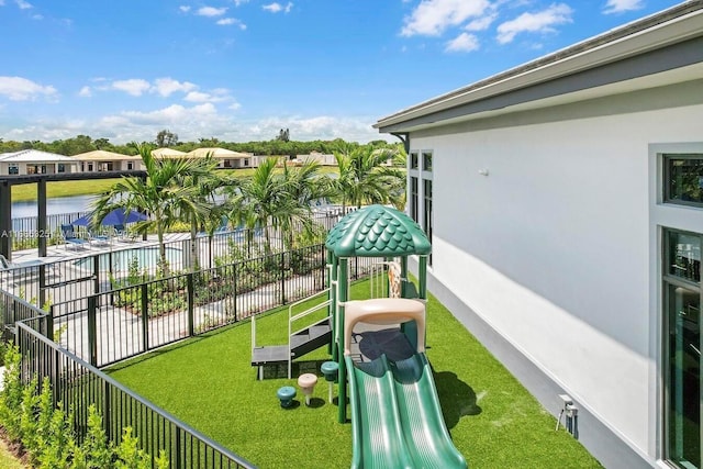 view of play area featuring a water view and a fenced in pool