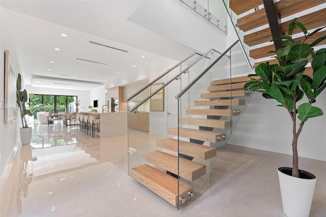 staircase with tile patterned floors