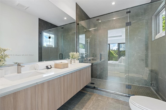 bathroom with vanity, a shower with shower door, toilet, and tile patterned floors