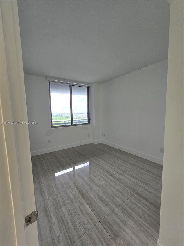 unfurnished room featuring hardwood / wood-style flooring