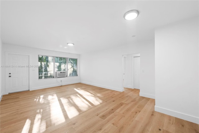 spare room with light wood-type flooring and cooling unit