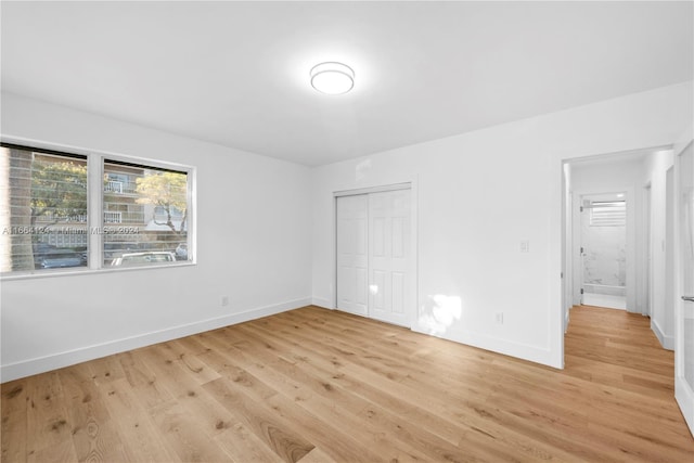 spare room with light hardwood / wood-style flooring