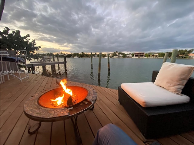 view of dock featuring a water view and an outdoor fire pit