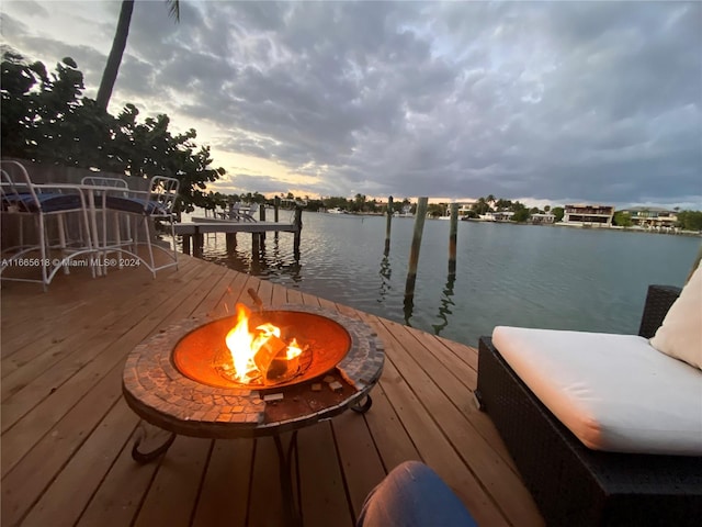 dock area featuring a water view and an outdoor fire pit