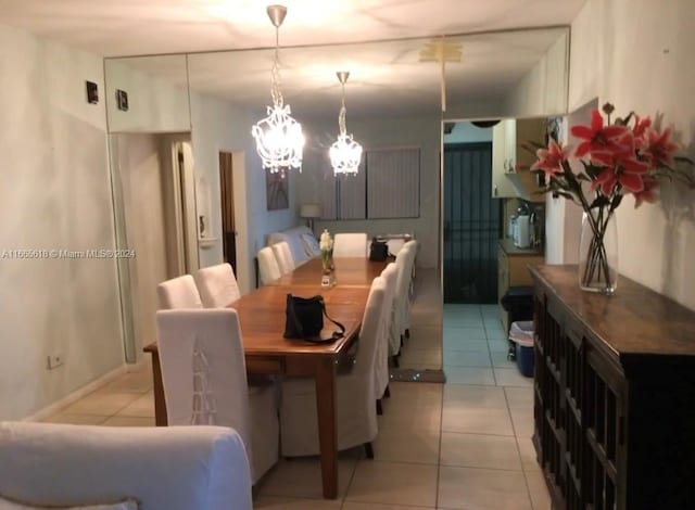 dining room featuring a notable chandelier and light tile patterned floors