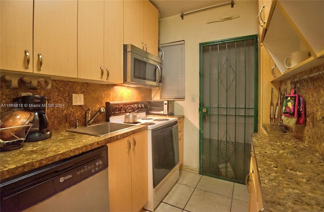 kitchen with light tile patterned flooring, sink, decorative backsplash, light brown cabinets, and appliances with stainless steel finishes