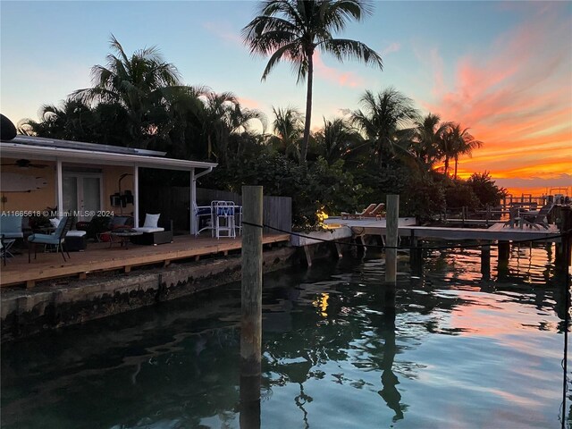 dock area featuring a deck with water view